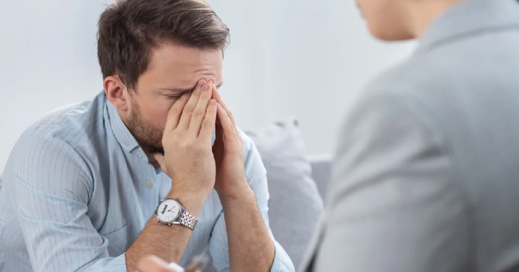 A man getting therapy, sitting across from a counselor, addressing challenges related to obsessive-compulsive disorder (OCD) in Buford, GA.